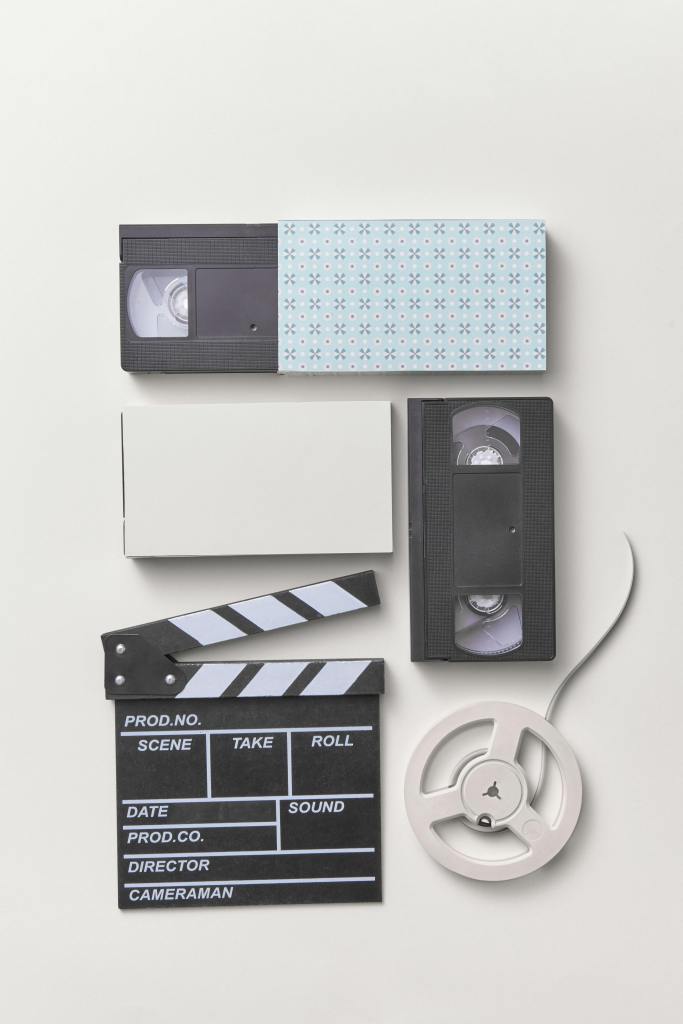https://www.pexels.com/photo/video-cassettes-and-clapper-on-white-studio-background-9227661/